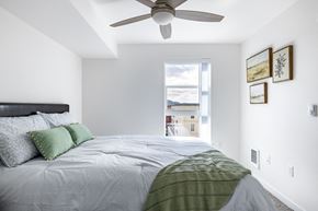 Portland apartment for rent - A bedroom with a large bed and a ceiling fan.at Traditions at Hazelwood, Portland