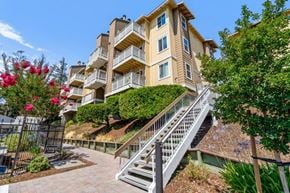 Castro Valley apartment for rent - A multi-story building with a staircase leading to the entrance.