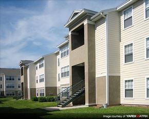 Orlando apartment for rent - A building with a staircase leading to a balcony.
