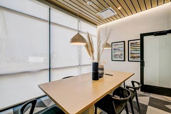 A meeting room with white walls and a wooden ceiling