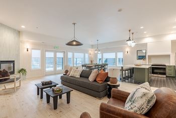 A living room with a grey couch and a brown leather chair