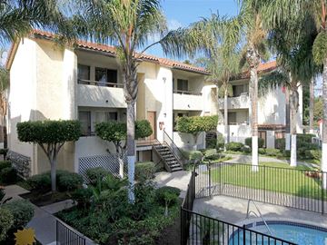 San Ysidro apartment for rent - A pool is surrounded by a black fence in a sunny backyard.