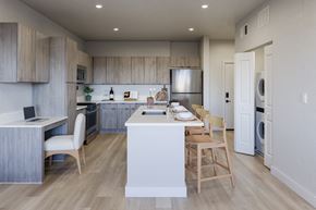 Las Vegas apartment for rent - A modern kitchen with wooden cabinets and a white island.