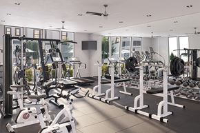 Rocklin apartment for rent - a gym with cardio equipment and a flat screen tv