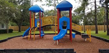 Ruskin apartment for rent - a playground with two slides and a swing set