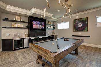 Game room with billiards table, shuffle board, and kitchenette