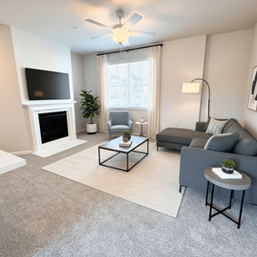 Sacramento apartment for rent - A living room with a grey couch, a white fireplace, and a television on the wall at Laguna, CA, 95823