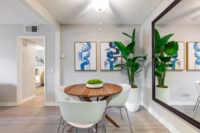 Cypress apartment for rent - A dining room with a wooden table and white chairs.