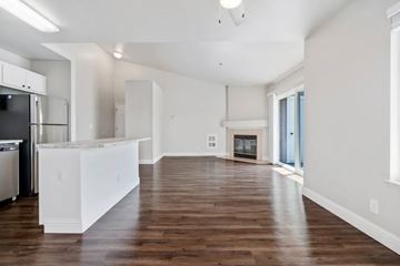 Castro Valley apartment for rent - A kitchen with white cabinets and a wooden floor.