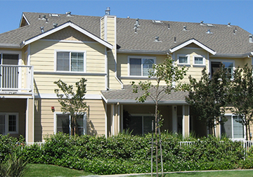 Napa townhouse for rent - A large, two-story house with a beige exterior and a gray roof.
