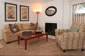 Sacramento apartment for rent - A living room with a couch, chair, and fireplace.