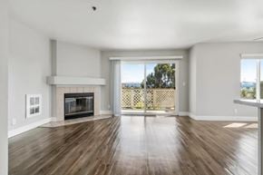 Castro Valley apartment for rent - A spacious living room with a fireplace and sliding glass doors.