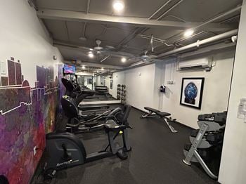 A gym with treadmills, exercise bikes