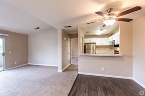 Santa Rosa apartment for rent - an empty living room with a ceiling fan and a kitchen at THE MEADOWS, Santa Rosa, CA