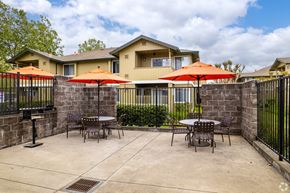 Santa Rosa apartment for rent - patio with tables and umbrellas and our house in the background at THE MEADOWS, California