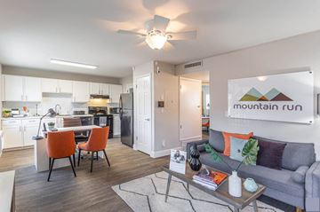 Orem apartment for rent - a living room and kitchen with a couch and a table