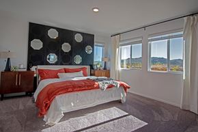 Reno apartment for rent - a bedroom with a bed and a black and white accent wall