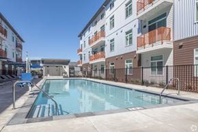 Davis apartment for rent - a swimming pool in front of a building