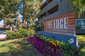 Fremont apartment for rent - Edge on the Boulevard - Building Sign, Building Exterior, Tall Trees, and Landscape at The Edge on the Boulevard, California, 94555