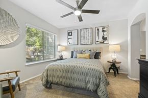 Cottonwood Heights apartment for rent - a bedroom with a bed and a ceiling fan at Ascent Apartments, Utah, 84121