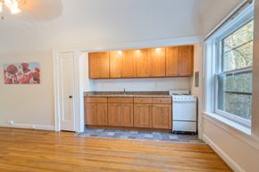 Portland apartment for rent - A kitchen with wooden cabinets and a white dishwasher.at Palladian Apartments, Oregon, 97201?