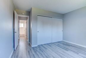 Tigard apartment for rent - A hallway with a white door and a white closet.at Tigardville Apartments, Tigard, OR