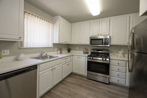 Davis apartment for rent - a kitchen with white cabinets and stainless steel appliances
