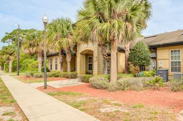 Titusville apartment for rent - A row of houses with a sidewalk in front.