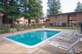 Sacramento apartment for rent - A swimming pool surrounded by a fence and chairs.