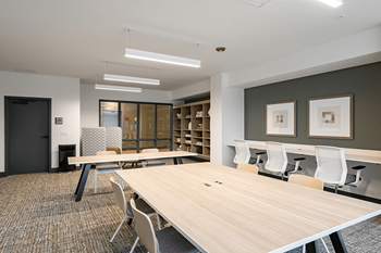 A meeting room with tables and chairs