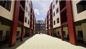 Oxnard apartment for rent - A long corridor with red and white buildings on either side at Vintage at Lockwood Apartments, Oxnard