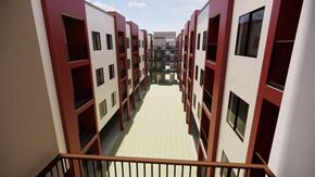 Oxnard apartment for rent - A long hallway with red and white buildings on either side at Vintage at Lockwood Apartments, Oxnard, California