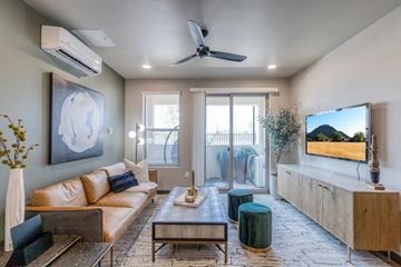 Reno apartment for rent - a living room with a couch and a ceiling fan