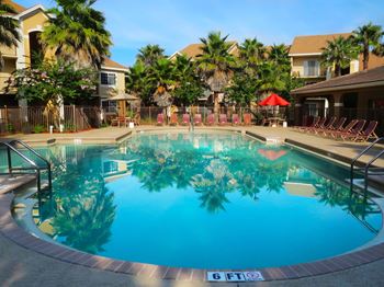 San marco resort style swimming pool with lounge chairs and umbrellas