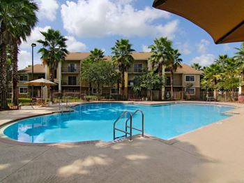 San marco resort style swimming pool with lounge chairs and umbrellas