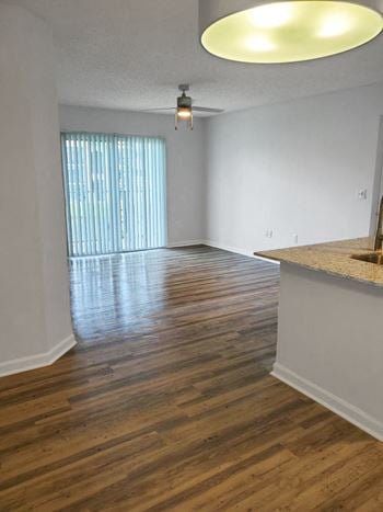 San marco apartment home living area with balcony and ceiling fan with lots of natural lighting
