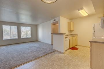 Pasco apartment for rent - A kitchen area with a counter and a fridge.