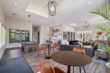 Reno apartment for rent - A modern living room with a pool table and a dining table.