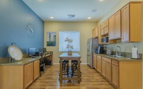 Reno apartment for rent - a kitchen with wooden cabinets and a dining room table
