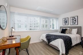 Sacramento apartment for rent - 1-Bedroom Apartments in Downtown Sacramento, CA - Mod at Midtown - Furnished Bedroom with Wood Plank Flooring, Wall to Wall Windows, White Walls, and Desk Area