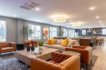 Reno apartment for rent - A living room with brown leather furniture and a fireplace.
