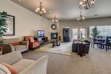 Laughlin apartment for rent - A living room with a grey carpet and a chandelier.