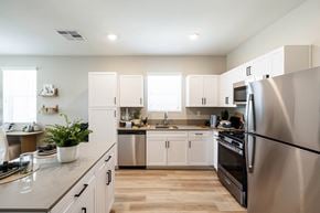 Las Vegas apartment for rent - a kitchen with stainless steel appliances and white cabinets at BASE APARTMENT HOMES, LAS VEGAS, NV 89166