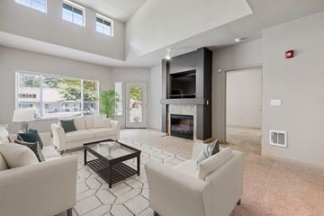 Olympia apartment for rent - a living room with white furniture and a fireplace