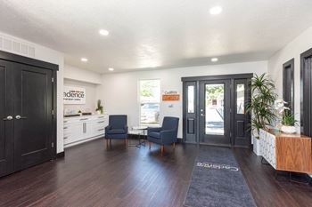 A living room with two chairs and a table and a door