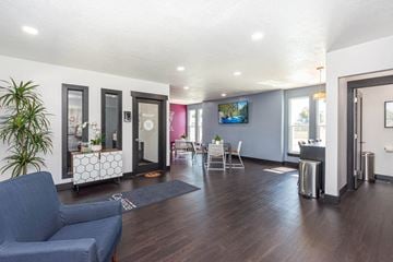 Roy apartment for rent - a living room with a couch and a table and a tv