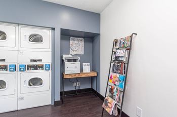 A laundry room with washer and dryer and a ladder