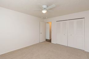 Roy apartment for rent - a bedroom with a ceiling fan and a closet at Cadence Apartments, Roy, UT 84067