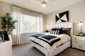 Las Vegas apartment for rent - A bedroom with a large bed and a ceiling fan.
