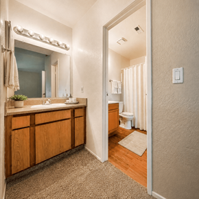 Tracy apartment for rent - A bathroom with a sink, mirror, and toilet.